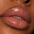 Neutral pink lipgloss on black model with warm undertones
