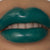 Close-up image of a person wearing forest green water activated eyeliner on their lips.